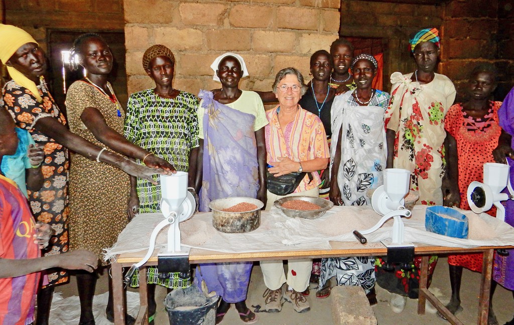Women celebrate gift of hand grain grinders from Dr. Ann